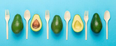 Save the planet, no plastic. Eco disposable tableware with avocado seeds on blue background,...