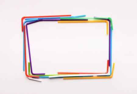 Colored frame of plastic straws with copy space inside for recycling conceptual text, isolated on...