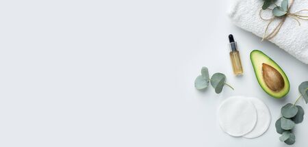 Vegetarian products concept, natural cosmetics of eco ingredients. Sliced avocado and small oil bottle isolated on white background, panorama, copy spaceの写真素材