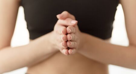 Mudra, yoga concept. Woman practicing yoga, holding hands together and prayingの写真素材