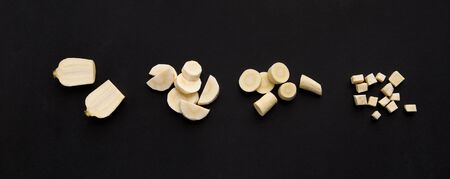 Food blog. Fresh cutting turnip on different pieces isolated on black background, wide panoramaの写真素材
