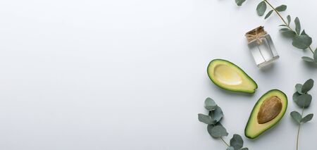 Spa at home. Avocado butter with essential oil for skincare natural cosmetics isolated on white background, panorama, copy spaceの写真素材