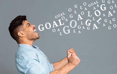 Soccer fan. Euphoric guy, football lover emotionally screaming over gray background with word goal...