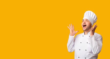 Excited Cook Man Screaming Holding Hands Near Mouth Standing On Yellow Studio Background. Panorama, Empty Spaceの写真素材
