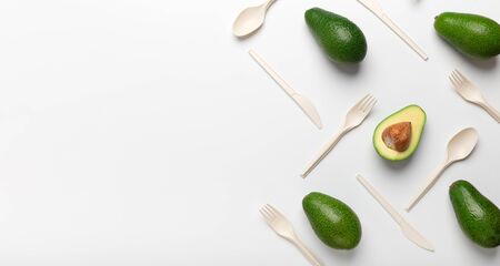 Bioplastic - Great alternative to plastic disposable cutlery, Avocados and disposable spoons isolated on white background, panorama, copy spaceの写真素材