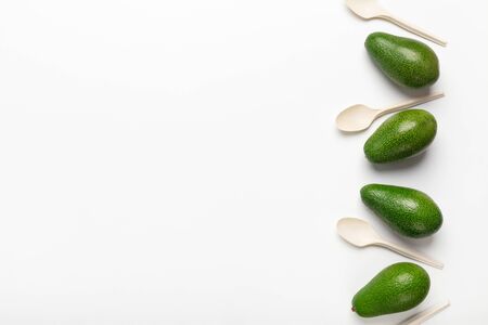 Avocado Seeds for Biodegradable Single-Use Cutlery. Collage of avocado and disposable spoons on white background, copy spaceの写真素材