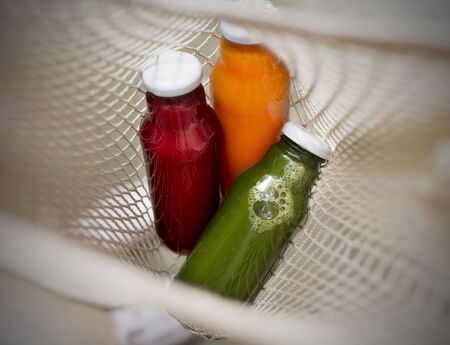 Healthy nutrition. Fresh detox cocktails inside zero waste bag, blurred backgroundの写真素材
