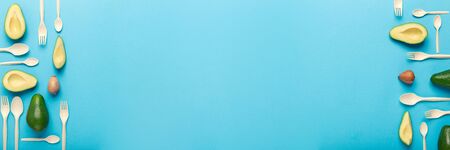 Bioplastic, biodegradable disposable tableware of natural avocado seeds, blue background, wide panorama, copy space, bannerの写真素材