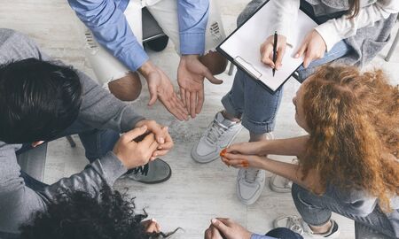Trust circle. Diverse people sharing their problems with psychologist at group therapy session,...