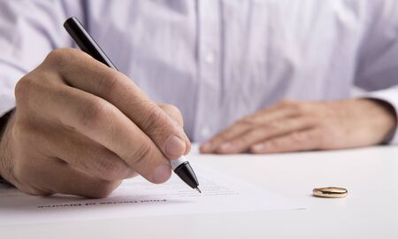 Husband sign divorce decree ending relationships with wife, breaking up or split officially....