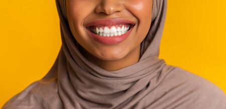 Stomatology Concept. Closeup of perfect white smile of black muslim woman in headscarf, happy after...