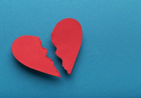 Sign of divorce. Broken paper heart on blue background, top view, copy spaceの写真素材