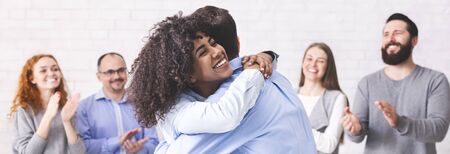 Trust exercise. Diverse people embracing during group meeting, happy to see each other, panorama...