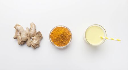 Turmeric powder and ginger root on white background with healthy cocktail. Top view. Flat lay, panoramaの写真素材