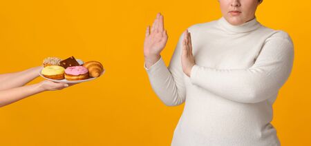 Say No To Obesity. Unrecognizable Fat Woman Rejecting Plate With Tasty Delicious Sweets, Showing...