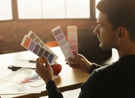 Designer's Lifestyle. Millennial Guy Working With Color Palettes And Samples Sitting At Laptop In...