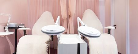 Room in beauty salon with Pink Interior. Relax for foot and legs, big leather comfortable armchairs for pedicure, wide panoramaの写真素材