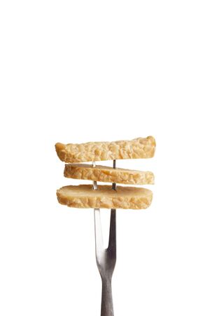 Tasty soybean appetizer Tempeh on fork, isolated on white background, empty spaceの写真素材