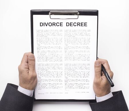 Relationship crisis, breakup. Husband holding divorce decree documents, white backgroundの写真素材