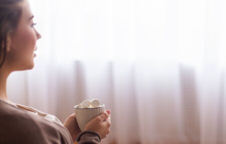 Sweet life. Young woman enjoying cup of hot cocoa with marshmallows, empty space
