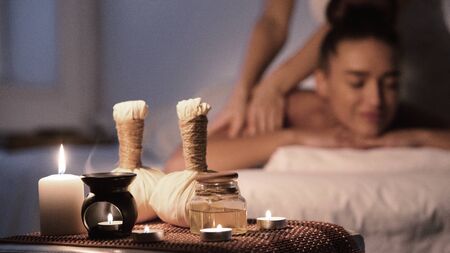 Thai massage. Woman receiving back massage, relaxing in spa and enjoying aroma therapyの写真素材