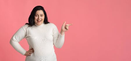 Fashion Clothes For Overweight People Concept. Excited Plump Woman Pointing Aside At Copy Space Over...