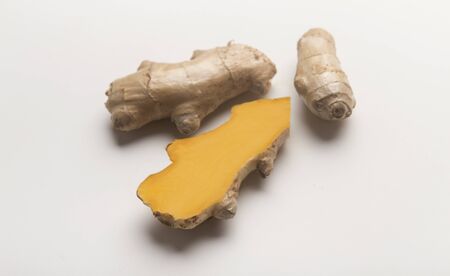 Yellow fresh Turmeric root or Curcuma longa on white background