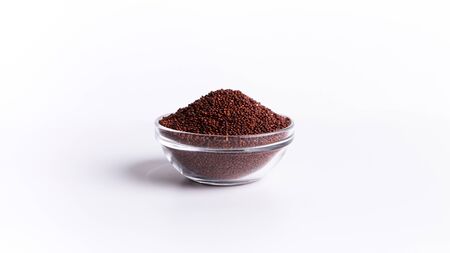 Food swap. Red quinoa In glass plate on white background free spaceの写真素材