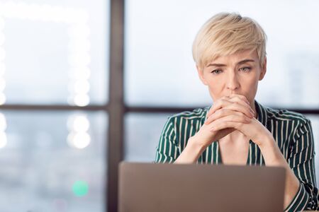 Stressful Work. Anxious Business Woman Thinking On Probems Sitting At Laptop In Modern Office. Free Space, Selective Focus