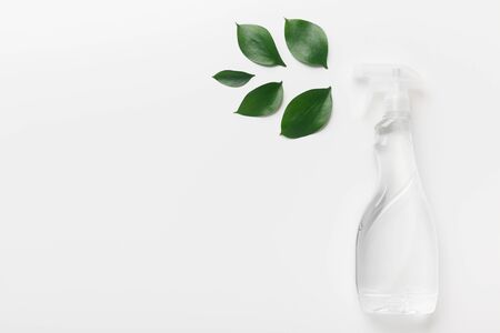 White spray bottle with leaves, Spray for eco friendly natural cleaning, white background, copy spaceの写真素材