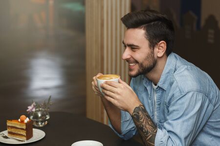 Man On A Romantic Date, Cheerful Guy Smiling To Girlfriend Having Coffee In Cafe. First Date...