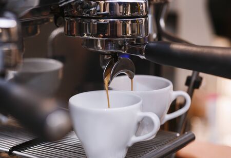 Closeup Of Working Coffee Machine With Cups, Barista Making Espresso In Coffeeshop. Selective Focus, Croppedの写真素材