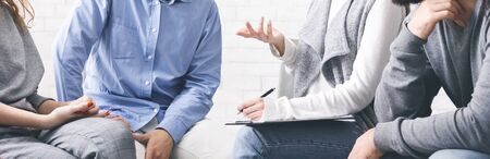 Unrecognizable people discussing their problems with psychologist at group therapy session, cropped image, panoramaの写真素材