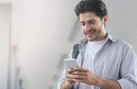 Portrait Of Handsome Young Man Using Smartphone While Waiting For His Flight In Airport, Selective...