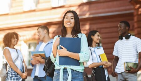 Loans For Education Concept. Portrait Of Happy Asian Student Girl Posing Outdoors In Campus With Her...