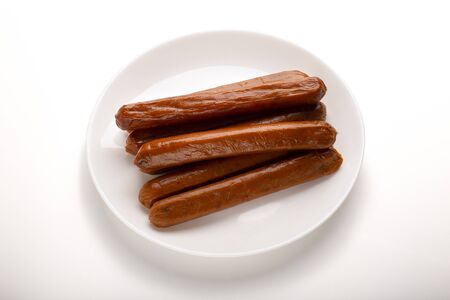 Food swap. Meatless sausages on plate isolated on white background, free space