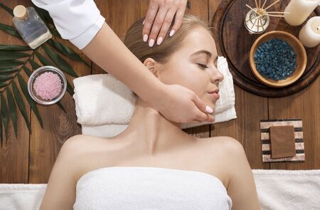 Masseur doing spa massage for young girl, top viewの写真素材