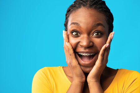 Omg. Excited Black Lady Screaming In Excitement Touching Face Looking At Camera Posing Over Blue...