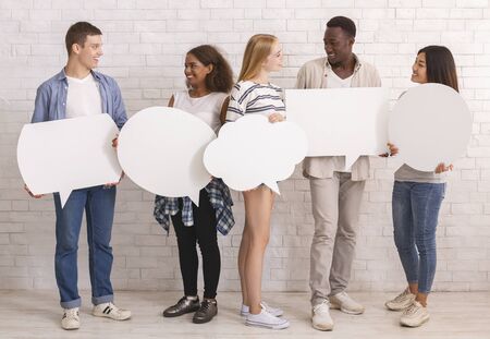 Multiracial teenagers with white communication bubbles having conversation, self-expression concept