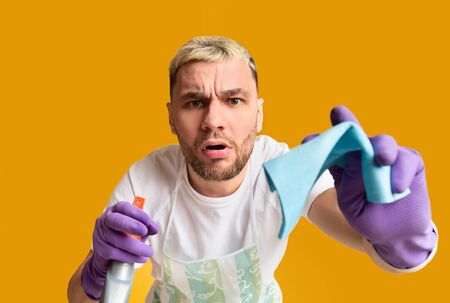 Housekeeping concept. Funny boy wiping screen sponge, free space