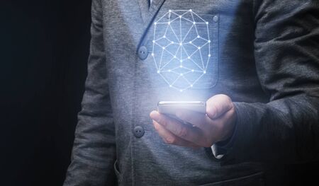 Smart technologies concept. Collage with polygonal human face over smartphone in businessman's hand,...