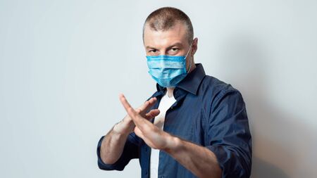 Coronavirus Protection. Man In Protective Medical Mask Standing In Ready To Fight Pose Over Gray...