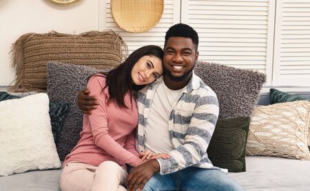 Happy african american guy and european girl stayed home