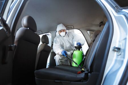 Rules of how to protect your life during coronavirus. Man in protective suit cleaning with chemicals...