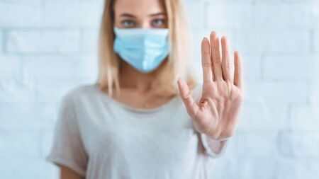 Distance during quarantine concept. Girl fenced off with hand, panoramaの写真素材
