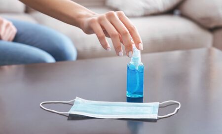 Girl takes antiseptic and medicine mask.の写真素材