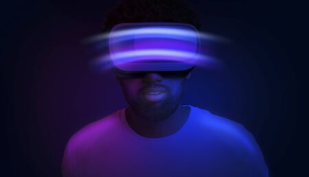 Modern Entertainment. Creative Collage In Neon Colors Of Amazed Black Man In VR Headset Standing...