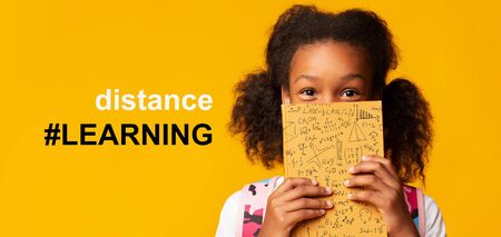 Remote education during COVID-19 epidemic. Cute girl hiding behind book and hashtag DISTANCE LEARNING, collage on orange background. Panoramaの写真素材