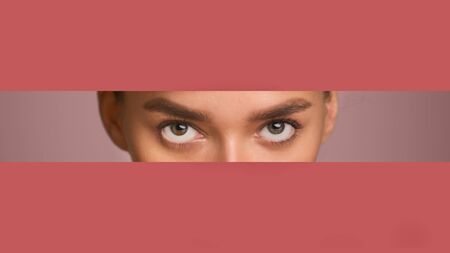 Discount Concept. Attractive girl peeping out of torn pastel red paper, empty space