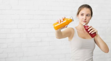 Cheerful sportive girl drinking vitamin detox drink and fighting with viruses and flu easily, panorama, copy spaceの写真素材
